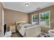 Bedroom with bed, two windows, gray-tone walls and trim, with light-colored wood floor at 4668 Raiders Ridge Ct, Lithonia, GA 30038