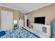 Bedroom with bed, television, gray-tone walls and trim, with light-colored wood floor at 4668 Raiders Ridge Ct, Lithonia, GA 30038