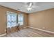 Neutral bedroom featuring a ceiling fan, two windows, luxury vinyl plank flooring, and neutral paint at 4668 Raiders Ridge Ct, Lithonia, GA 30038