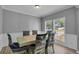 Bright dining room with light-colored walls and trim, featuring a table with six chairs near window at 4668 Raiders Ridge Ct, Lithonia, GA 30038
