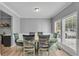 Bright dining room with light-colored walls and trim, featuring a table with six chairs near window at 4668 Raiders Ridge Ct, Lithonia, GA 30038