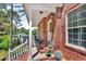 Charming brick home featuring a cozy front porch with seating area and traditional design at 4668 Raiders Ridge Ct, Lithonia, GA 30038