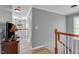 Upstairs hallway featuring a view of a staircase, light gray paint, and luxury vinyl plank flooring at 4668 Raiders Ridge Ct, Lithonia, GA 30038