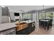 Open-concept kitchen featuring a stainless steel farmhouse sink and island at 4668 Raiders Ridge Ct, Lithonia, GA 30038