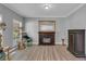 Cozy living room featuring a decorative fireplace, two windows, wood floors and neutral gray walls at 4668 Raiders Ridge Ct, Lithonia, GA 30038