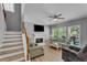 Cozy living room featuring a fireplace and staircase at 4668 Raiders Ridge Ct, Lithonia, GA 30038