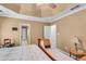 Neutral main bedroom featuring a tray ceiling, a ceiling fan, with views to an ensuite and a walk-in closet at 4668 Raiders Ridge Ct, Lithonia, GA 30038