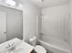 Clean and modern bathroom with a shower-tub combo and ample vanity space at 4673 Hairston Crossing Way, Stone Mountain, GA 30083