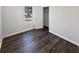 Well-lit bedroom with wood flooring, a large window, and a closet for storage at 4673 Hairston Crossing Way, Stone Mountain, GA 30083