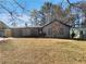 Charming single story home featuring a stone accent wall, garage, and well-maintained lawn at 4673 Hairston Crossing Way, Stone Mountain, GA 30083