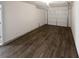 Spacious garage with wood flooring and a door, ready for parking and storage at 4673 Hairston Crossing Way, Stone Mountain, GA 30083