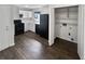 Efficient kitchen with white cabinets, black appliances, and wood flooring, creating a clean and practical space at 4673 Hairston Crossing Way, Stone Mountain, GA 30083