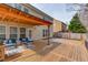 Expansive back deck featuring outdoor seating, a barbecue grill, and a manicured lawn at 1169 Harvest Brook Dr, Lawrenceville, GA 30043