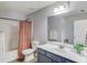 Modern bathroom with vanity, neutral walls, and shower with coral curtain at 1169 Harvest Brook Dr, Lawrenceville, GA 30043