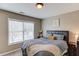 Bedroom with dark wood furniture, grey bedding and large bright window at 1169 Harvest Brook Dr, Lawrenceville, GA 30043