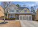 Charming two-story home featuring a three-car garage, stone accents and well-maintained landscaping at 1169 Harvest Brook Dr, Lawrenceville, GA 30043