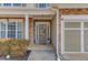 Inviting front entrance with a decorative wreath, stone accents, and a well-lit porch at 1169 Harvest Brook Dr, Lawrenceville, GA 30043