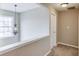 Hallway featuring neutral paint, light fixture, and a window at 1169 Harvest Brook Dr, Lawrenceville, GA 30043