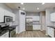 Spacious kitchen featuring white cabinetry, stainless steel appliances, and a black granite countertop with modern fixtures at 1169 Harvest Brook Dr, Lawrenceville, GA 30043