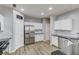 Well-lit kitchen with white cabinets, stainless steel appliances, dark countertops, and subway tile backsplash at 1169 Harvest Brook Dr, Lawrenceville, GA 30043