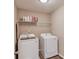Functional laundry room with modern washer and dryer and ample storage at 1169 Harvest Brook Dr, Lawrenceville, GA 30043