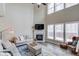 Inviting living room featuring soaring ceilings, a fireplace, and large windows offering plenty of natural light at 1169 Harvest Brook Dr, Lawrenceville, GA 30043