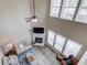 Bright living room with fireplace, high ceilings, ceiling fan and lots of natural light from large windows at 1169 Harvest Brook Dr, Lawrenceville, GA 30043