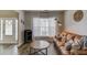 Comfortable living room boasting wood flooring, a leather sofa, stylish decor, and ample natural light at 1169 Harvest Brook Dr, Lawrenceville, GA 30043