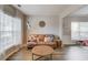 Cozy living room showcasing a comfortable leather sofa, stylish decor, and ample natural light at 1169 Harvest Brook Dr, Lawrenceville, GA 30043