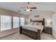 Spacious main bedroom with ceiling fan, large window, and plush carpet at 1169 Harvest Brook Dr, Lawrenceville, GA 30043
