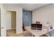 A well-lit home office with a guitar, desk, and calming blue accent wall at 1169 Harvest Brook Dr, Lawrenceville, GA 30043