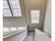 Carpeted staircase with white railings and multiple windows offering natural light to the upper level of the home at 1169 Harvest Brook Dr, Lawrenceville, GA 30043