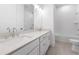 Bathroom with a double vanity, white quartz countertop, and a tub with tile surround at 2140 Parkside Ln, Roswell, GA 30076