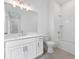 All-white bathroom with double vanity, gray tile floor, and a shower-tub combo with subway tile at 2140 Parkside Ln, Roswell, GA 30076