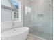 This bathroom offers a luxurious soaking tub and glass shower with marble surround at 2140 Parkside Ln, Roswell, GA 30076