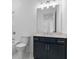 Modern bathroom featuring sleek vanity, a large mirror, and shower over tub with white tile surround at 2140 Parkside Ln, Roswell, GA 30076