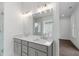 This bathroom offers a double sink vanity with gray cabinetry and a large mirror at 2140 Parkside Ln, Roswell, GA 30076