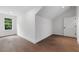 Bedroom with light hardwood floors, white walls, a window, and a door to a closet at 2140 Parkside Ln, Roswell, GA 30076
