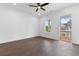 Bright bedroom with hardwood floors and access to a balcony overlooking the backyard at 2140 Parkside Ln, Roswell, GA 30076