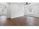 Spacious bedroom features hardwood floors, neutral walls, ceiling fan and bright, natural light at 2140 Parkside Ln, Roswell, GA 30076
