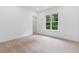 This is a spacious bedroom features carpet flooring, neutral walls, and bright, natural light at 2140 Parkside Ln, Roswell, GA 30076