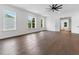 Spacious bedroom with hardwood floors, white walls, ceiling fan, and large windows with natural light at 2140 Parkside Ln, Roswell, GA 30076