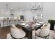 Open-concept kitchen and dining area with modern lighting and stainless-steel appliances at 2140 Parkside Ln, Roswell, GA 30076