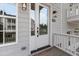 Elegant entryway with a glass-paneled door, stylish exterior lighting, and a charming brick-paved porch at 2140 Parkside Ln, Roswell, GA 30076