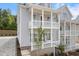 Side view of a charming two-story home with a double front porch and inviting entryway at 2140 Parkside Ln, Roswell, GA 30076