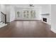 Inviting living room with hardwood floors, a modern fireplace, and abundant natural light from the large windows at 2140 Parkside Ln, Roswell, GA 30076