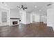 Spacious living room with dark hardwood floors, a modern fireplace, and large windows for ample natural light at 2140 Parkside Ln, Roswell, GA 30076
