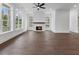 Bright and airy living room with hardwood floors, fireplace, and expansive windows offering natural light and views at 2140 Parkside Ln, Roswell, GA 30076