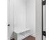Bright mud room with white paneled walls and bench, with cubbies for storage at 2140 Parkside Ln, Roswell, GA 30076