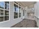 Cozy patio featuring brick flooring, white railings, and large windows, offering an inviting outdoor living space at 2140 Parkside Ln, Roswell, GA 30076